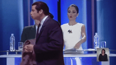 Man In Suit In Front Of Woman With Letter A GIF