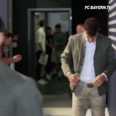 Man In Suit In Hallway With FC Bayern.tv GIF