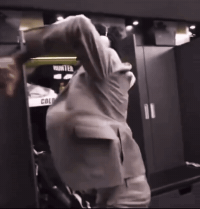 Man In Suit In Locker Room With Word Hunter GIF