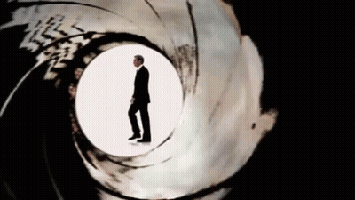Man In Suit In Middle Of Gun Barrel GIF