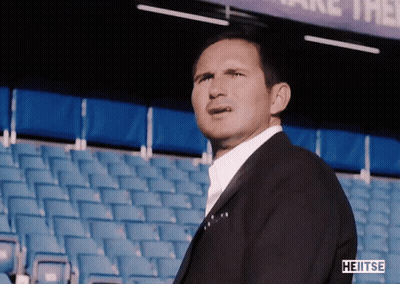 Man In Suit In Stadium With Sign Saying Take Them GIF