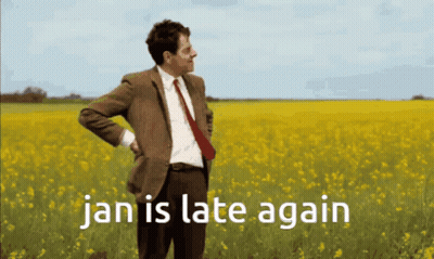 Man In Suit In Yellow Flowers Saying Jan Is Late Again GIF