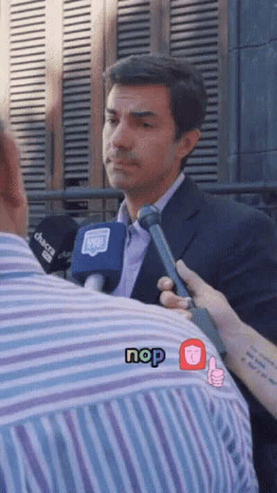 Man In Suit Interviewed By Person With Nop Sticker GIF