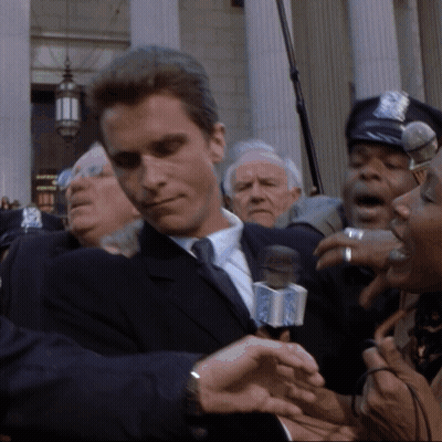 Man In Suit Interviewed By Woman With NBC Microphone GIF