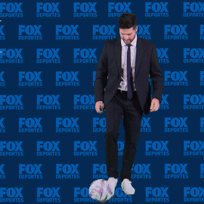 Man In Suit Juggling Soccer Ball In Front Of Fox Deportes Background GIF