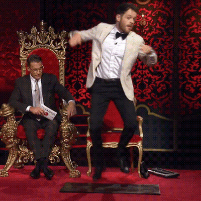 Man In Suit Jumping While Another Sits On Throne GIF