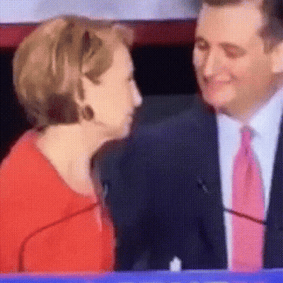 Man In Suit Kissing Woman In Red Shirt GIF