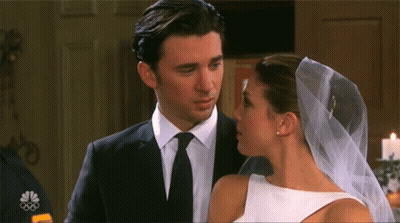Man In Suit Kissing Woman In White And Veil GIF