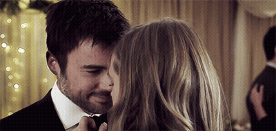 Man In Suit Kissing Woman's Forehead GIF
