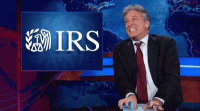 Man In Suit Laughing At IRS Screen GIF