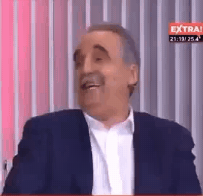 Man In Suit Laughing By Striped Wall GIF