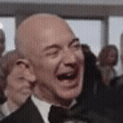 Man In Suit Laughing Eyes Closed In Crowd GIF