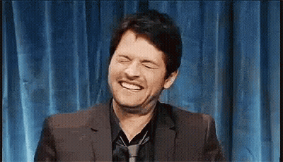 Man In Suit Laughing Eyes Closed GIF