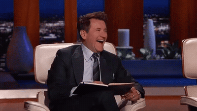 Man In Suit Laughing Holding Notebook GIF