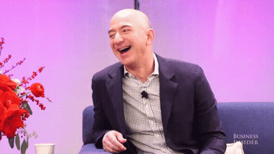 Man in Suit Laughing in Front of Business Insider Banner