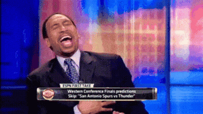 Man In Suit Laughing In Front Of ESPN Sign GIF