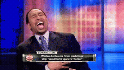 Man In Suit Laughing In Front Of Sports Talk Sign GIF