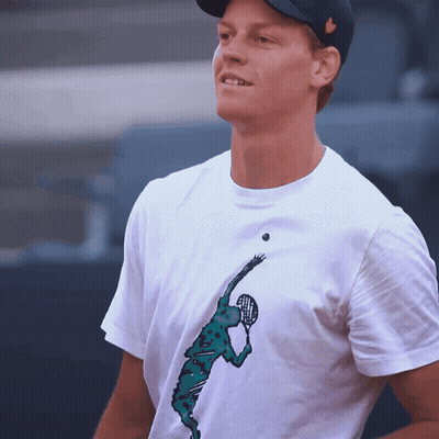 Man In Suit Laughing In Front Of Super Tennis Logo GIF
