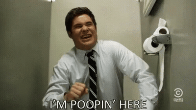 Man In Suit Laughing Next To Toilet Paper GIF
