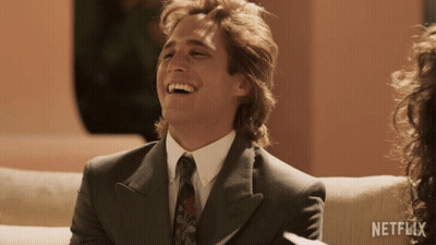 Man In Suit Laughing With Netflix Logo GIF