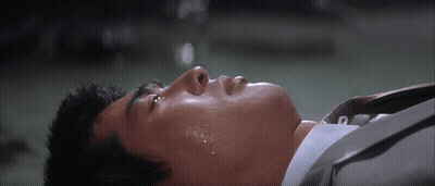 Man In Suit Laying Down With Sweat On Face GIF