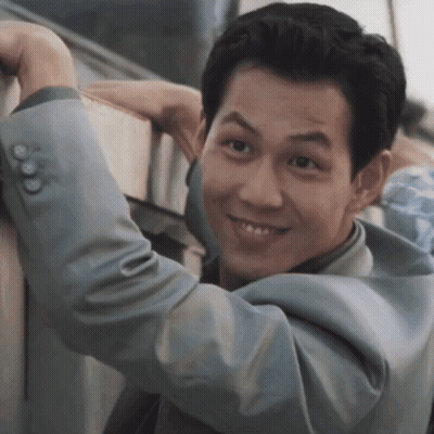 Man In Suit Leaning Against Wall GIF