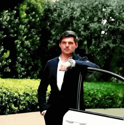 Man In Suit Leaning On Car Door GIF