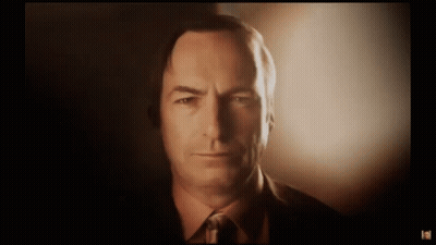 Man In Suit Looking At Camera With Glowing Light GIF