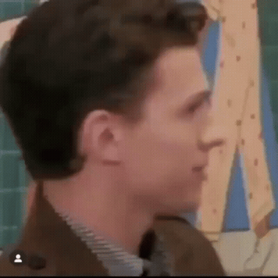 Man In Suit Looking At Cartoon Character GIF