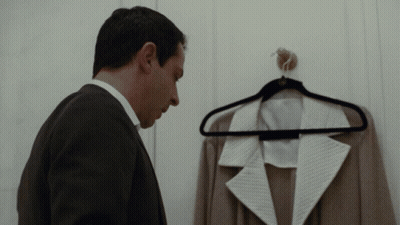 Man In Suit Looking At Jacket On Hanger GIF