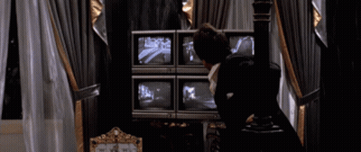Man In Suit Looking At Monitors Says You Wanna Play Games GIF