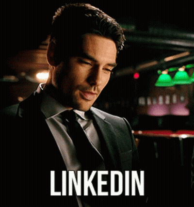 Man In Suit Looking At Phone LinkedIn GIF