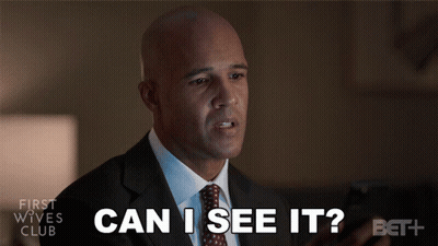 Man In Suit Looking At Phone Saying Can I See It GIF
