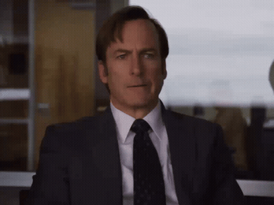 Man In Suit Looking Out Window GIF