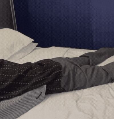 Man In Suit Lying On Bed Crossed Legs GIF
