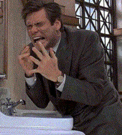 Man In Suit Making Face At Sink GIF