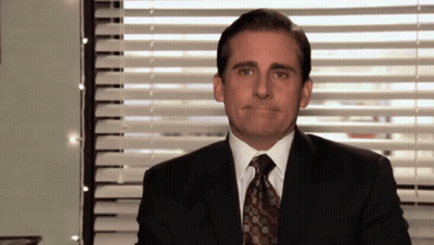 Man In Suit Making Face At Window With Blinds GIF