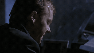 Man In Suit Making Face In Dark GIF