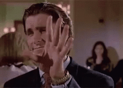 Man in Suit Making Face With Hands