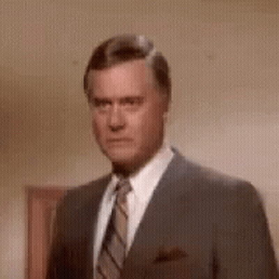 Man In Suit Making Funny Face GIF