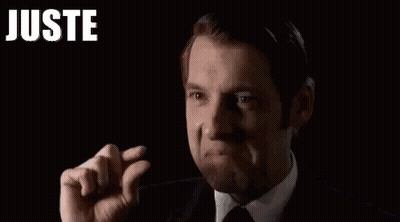 Man In Suit Making Funny Face And Raised Fist GIF