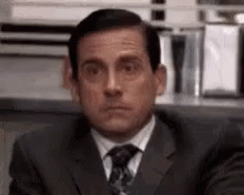 Man In Suit Making Funny Face At Desk GIF