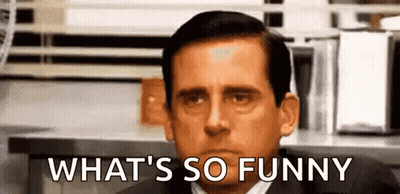 Man In Suit Making Funny Face At Table GIF
