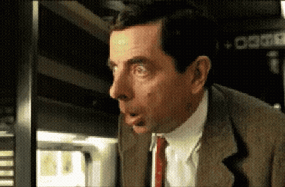 Man In Suit Making Funny Face At Window GIF