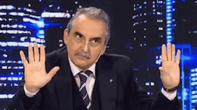Man In Suit Making Funny Face By City Skyline GIF