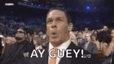 Man In Suit Making Funny Face In Crowd GIF