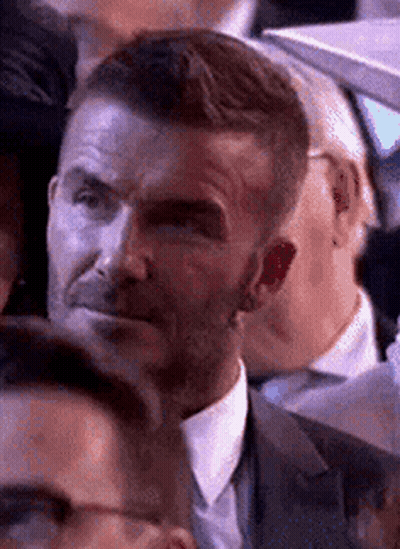 Man In Suit Making Funny Face In Crowd GIF