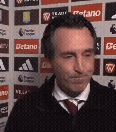 Man In Suit Making Funny Face In Front Of Company Logos GIF