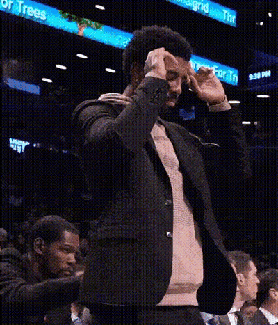 Man In Suit Making Funny Face In Stands GIF