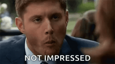 Man In Suit Making Funny Face Not Impressed GIF